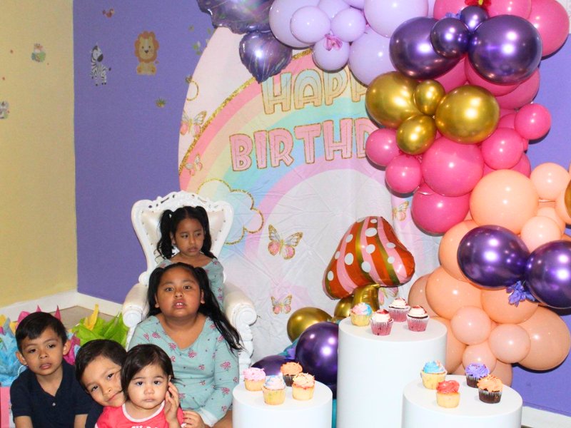 Birthday celebration with balloons and cupcakes