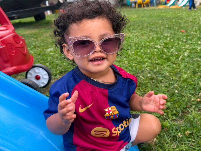 Little one in sunglasses enjoying outdoor play