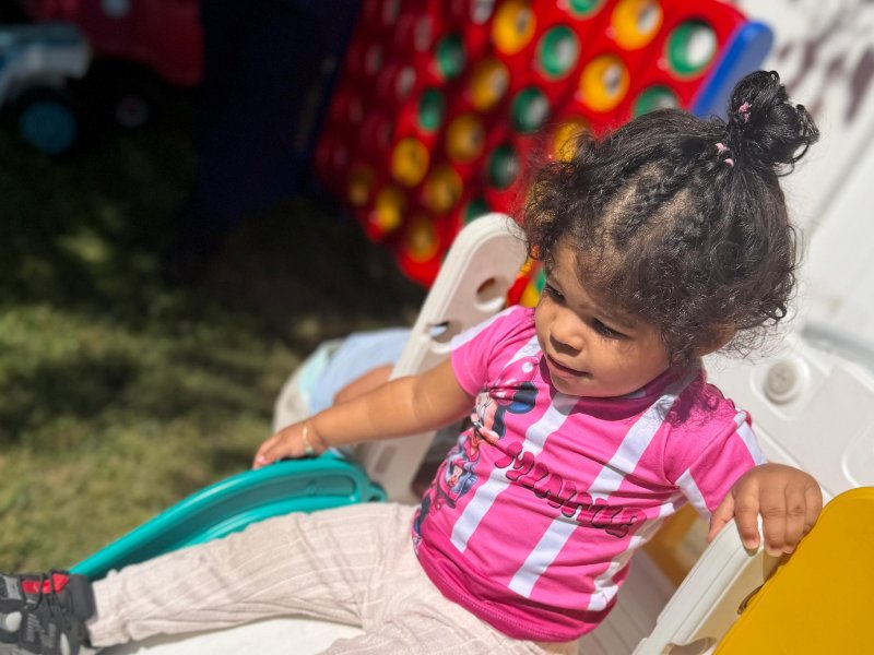 Toddler climbing on the outdoor playset